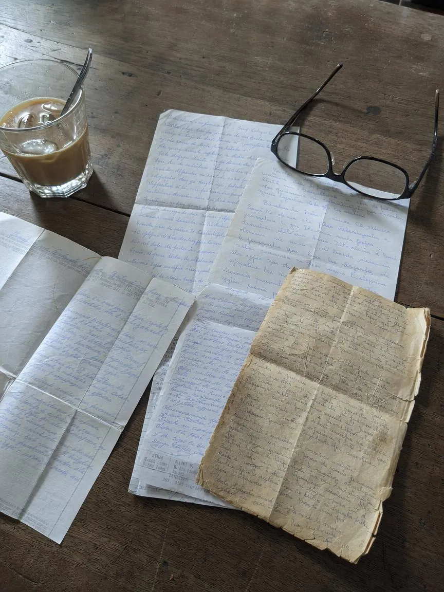 Handwritten prayers on the backs of receipts and envelopes, spread on a kitchen table